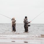 A man standing next to a body of water