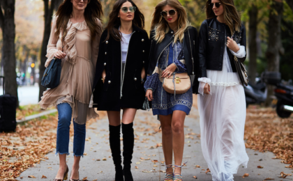 A group of girls wearing modern dresses and walking on the road